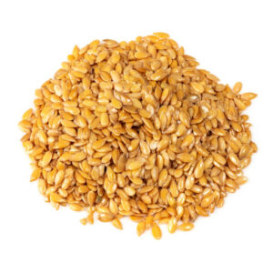 Pile of golden flax seeds closeup on white background