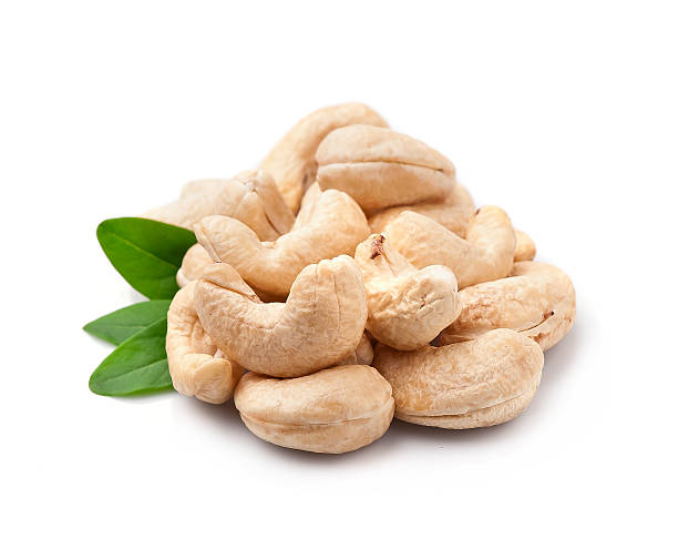 Cashew nuts heap with leaves on white backgrounds. healthy food ingredient