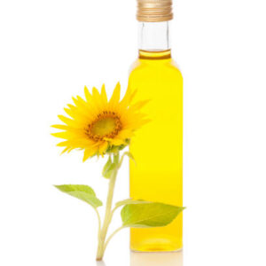 Sunflower oil and sunflower blossom isolated on white background.